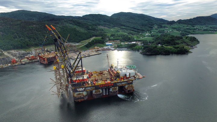 The semisubmersible crane vessel Thialf transports section of decommissioned jacket to disposal yard.