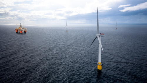 Hywind floating wind turbines withe the Snorre A semisubmersible platform in the distance.
