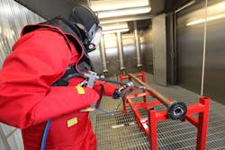 Operator decontaminating equipment with ultra-high-pressure water jet.