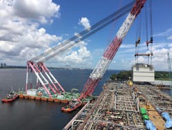 Installation of the first topsides module onto the FPSO Energean Power hull at Sembcorp Marine’s Admiralty Yard in Singapore. Installation of the first topsides module onto the FPSO Energean Power hull at Sembcorp Marine’s Admiralty Yard in Singapore.