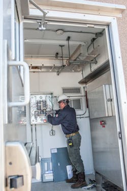 An employee performs onshore instrumentation and electrical work.