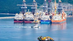 Tugboat sails past drill ships near the DSME shipyard in Okpo city, South Korea.