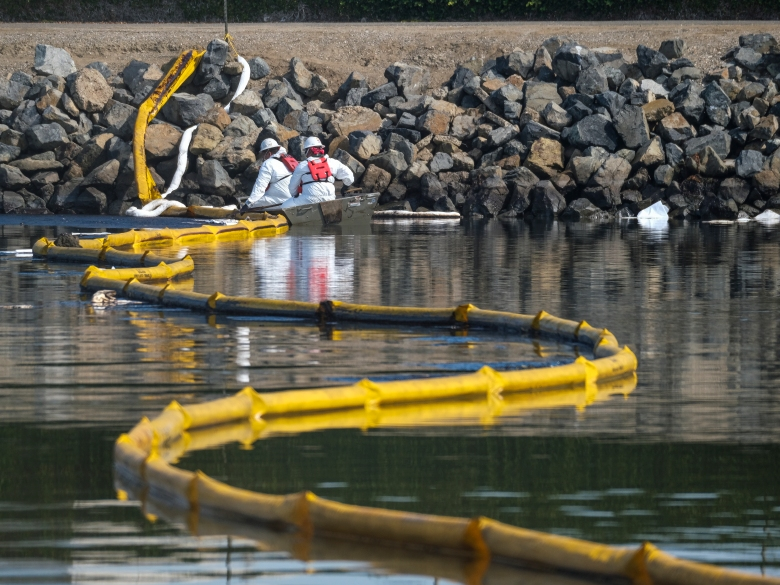 Crews deploy skimmers and booms to stop further incursion into the Wetlands Talbert Marsh in Huntington Beach, California, on Oct. 3, 2021.