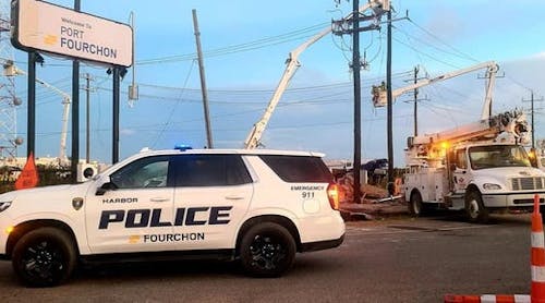 Power utility lineman work to restore power in Port Fourchon.