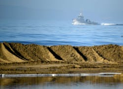 Boats help clean up an oil spill in Huntington Beach, California, Oct. 3, 2021.