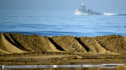 Boats help clean up an oil spill in Huntington Beach, California, Oct. 3, 2021.