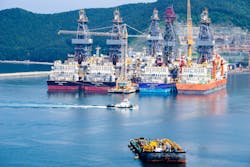 Tugboat sails past drillships in the Bay of Daewoo Shipbuilding and Marine Engineering DSME in Okpo city, South Korea.
