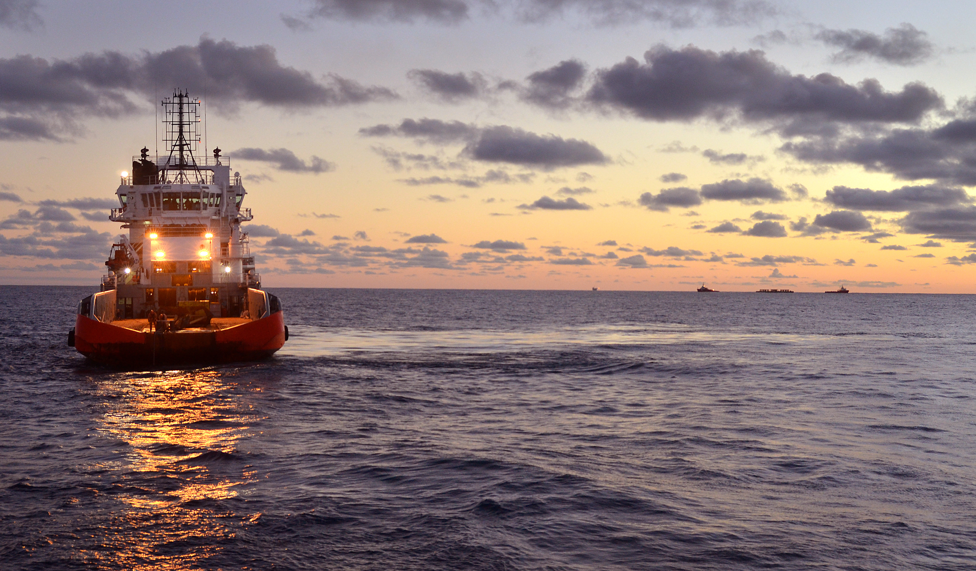Offshore workboat moves toward derrick barge and other vessels in the Bass Strait offshore Australia.