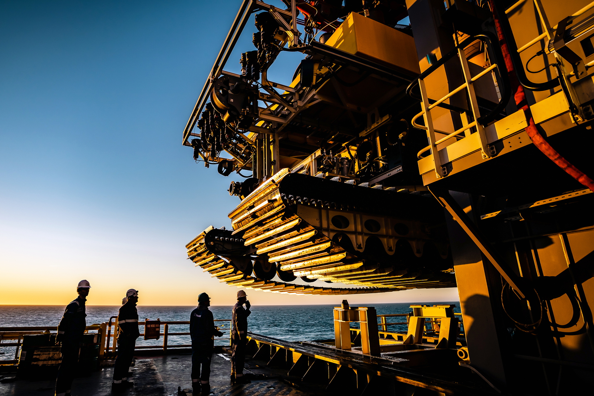 Engineers inspect the tracks of the pilot nodule collector vehicle.
