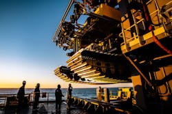 Engineers inspect the tracks of the pilot nodule collector vehicle. Engineers inspect the tracks of the pilot nodule collector vehicle.