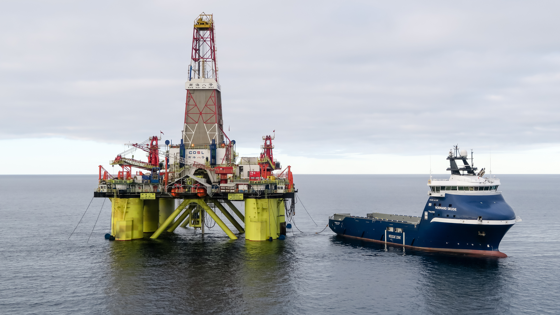 The Norwegian offshore supply vessel Normand Skude services a COSL oil drilling rig in the Kara Sea.