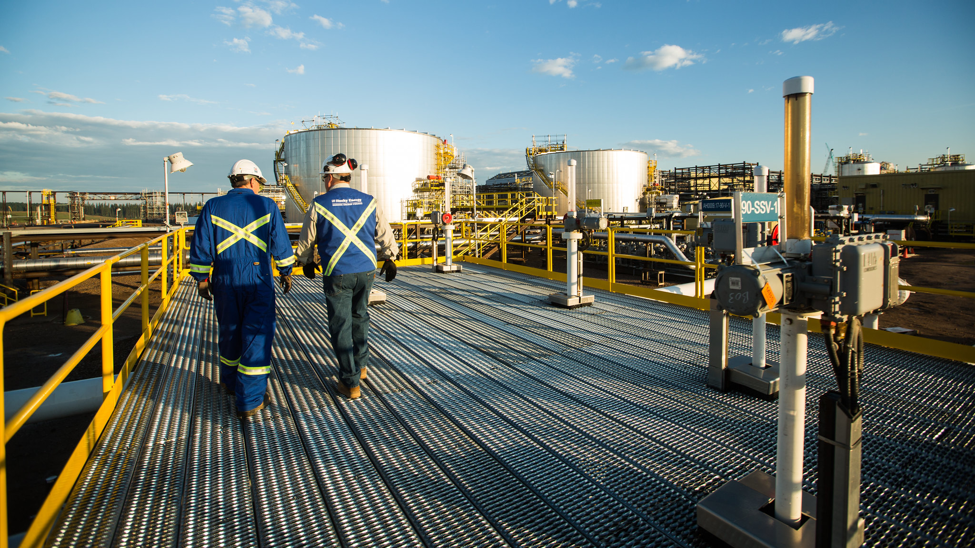 Workers walk through the Sunrise Energy Project in the Canadian oil sands in Northern Alberta, Canada. Operations started at the Sunrise Phase 1 in-situ oil sands project in December 2014.