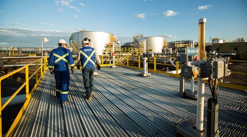 Workers walk through the Sunrise Energy Project in the Canadian oil sands in Northern Alberta, Canada. Operations started at the Sunrise Phase 1 in-situ oil sands project in December 2014.