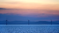 Offshore wind turbines operate at sunset off the Irish coast. Offshore wind turbines operate at sunset off the Irish coast.