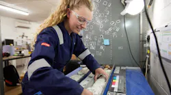 An employee prepares a sample for core logging.