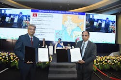 Joint Secretary (Refineries) Sunil Kumar and ONGC CMD RK Srivastava (right) exchange the signed contracts.