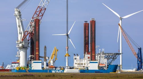 Offshore wind turbine supply vessel anchored and loading in port of Eemshaven, the Netherlands.