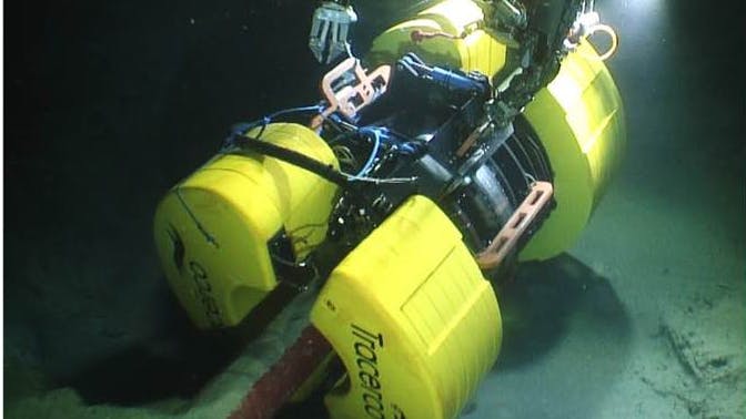 Tracerco's Discovery technology is shown being placed on a pipeline.