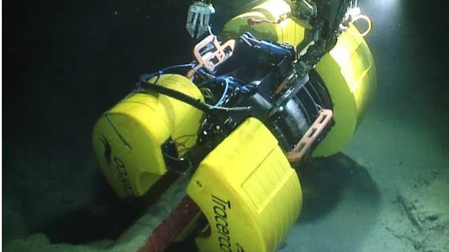 Tracerco's Discovery technology is shown being placed on a pipeline.