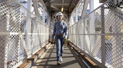 A worker walks along an offshore platform at Chevron's Anchor Field, a deepwater development with reservoir depths reaching 34,000 ft below the water surface. A worker walks along an offshore platform at Chevron's Anchor Field, a deepwater development with reservoir depths reaching 34,000 ft below the water surface.