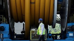 A worker walks past a spool of Baker Hughes flexible pipe at the company's Newcastle upon Tyne, UK facility. A worker walks past a spool of Baker Hughes flexible pipe at the company's Newcastle upon Tyne, UK facility.