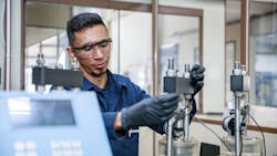 Fugro lab worker working with equipment. Fugro lab worker working with equipment.