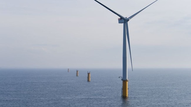 Single offshore wind turbine in a wind farm under construction off the English Coast, North Sea.