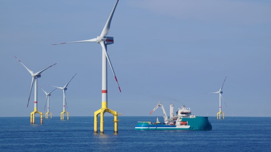 Offshore wind turbine with supply boat in the North Sea.