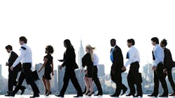 People in business attire walking. People in business attire walking.