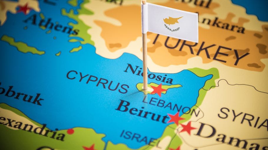 Cyprus marked with its flag on a map.
