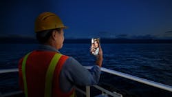 An AI-generated image depicts an offshore crew member video chatting with family. An AI-generated image depicts an offshore crew member video chatting with family.