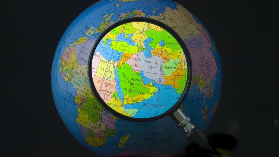 Magnifying glass focusing on Middle East.
