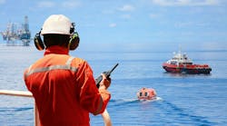 Worker in offshore oil and gas industry contacts operation team to check conditions Worker in offshore oil and gas industry contacts operation team to check conditions