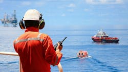 Worker in offshore oil and gas industry contacts operation team to check conditions Worker in offshore oil and gas industry contacts operation team to check conditions