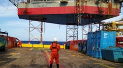 Marine crew get ready to work near jackup rig to receive cargo lift by crane operator Marine crew get ready to work near jackup rig to receive cargo lift by crane operator