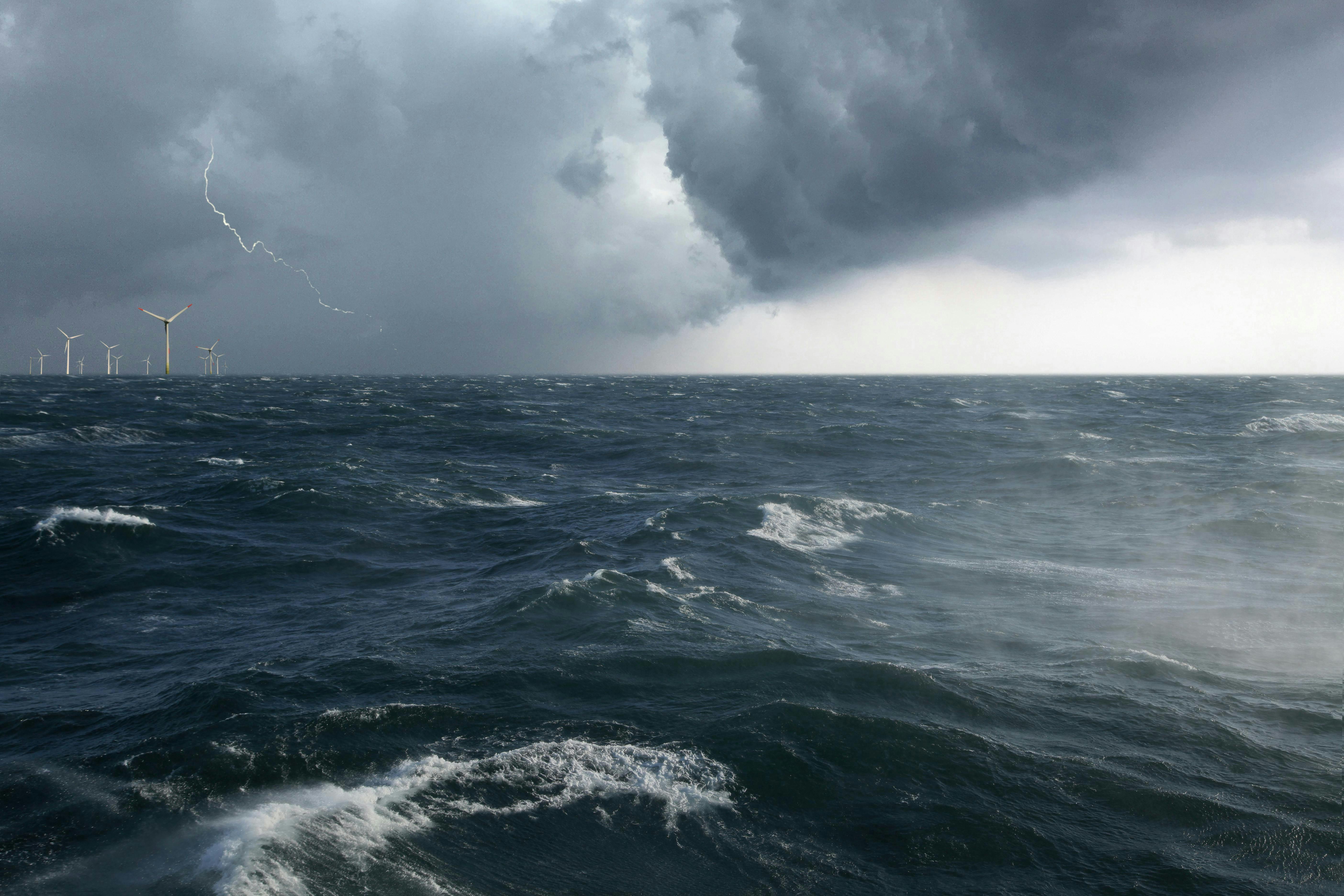 offshore wind farm during a lightning storm offshore wind farm during a lightning storm