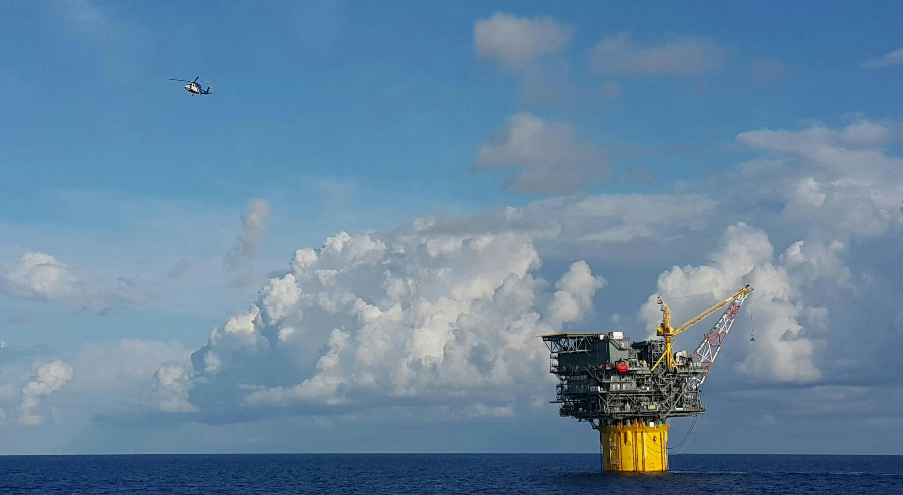 A helicopter leaving an oil and gas floating production and storage spar in Gulf Of Mexico A helicopter leaving an oil and gas floating production and storage spar in Gulf Of Mexico