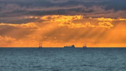Offshore drilling rigs and a vessel in the Gulf of Mexico Offshore drilling rigs and a vessel in the Gulf of Mexico