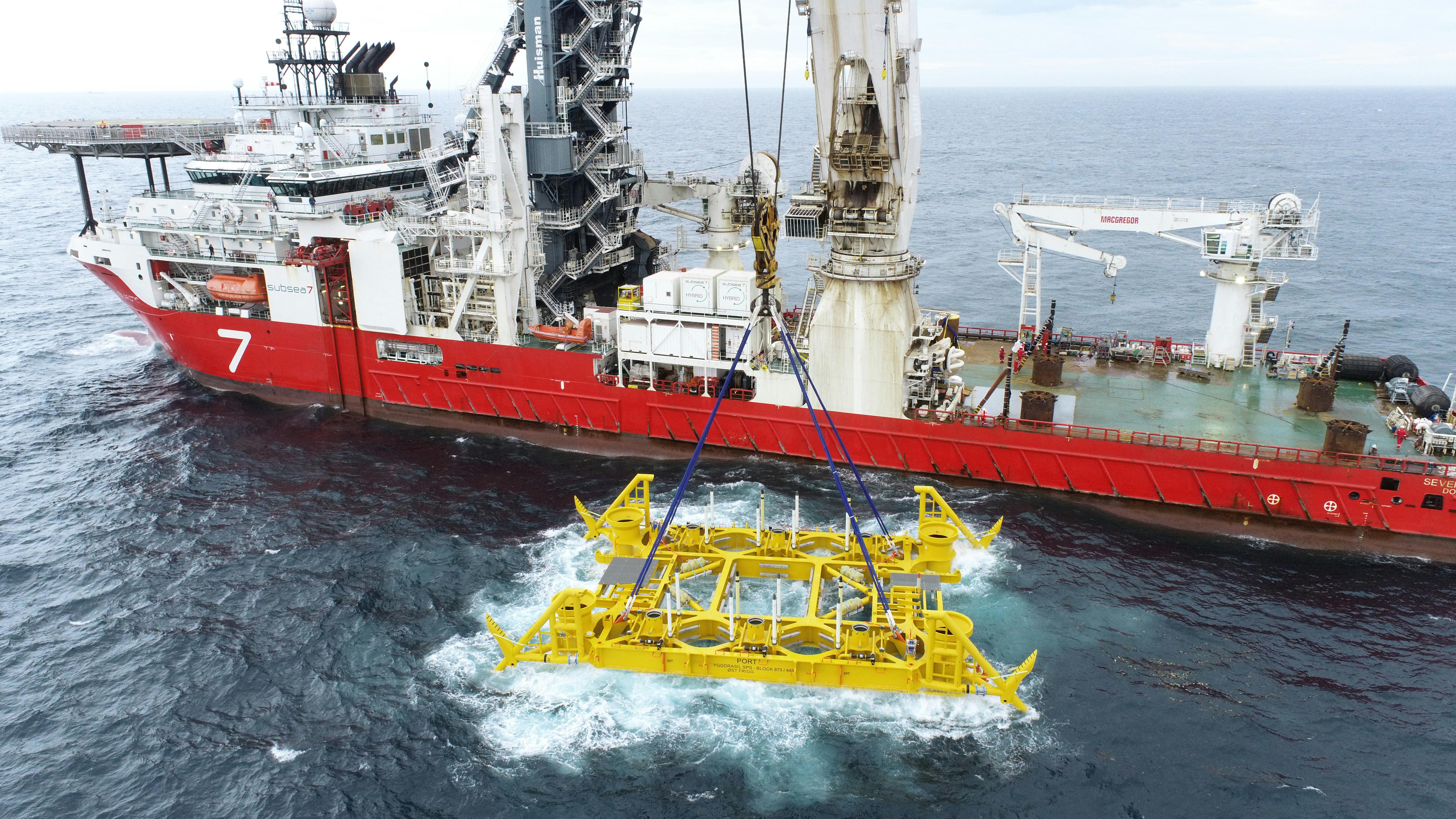 subsea template being lowered into water