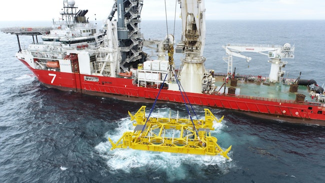 subsea template being lowered into water