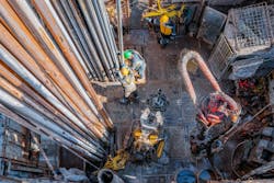 Offshore oil rig workers prepare tool and equipment for perforation oil and gas well at wellhead platform Offshore oil rig workers prepare tool and equipment for perforation oil and gas well at wellhead platform