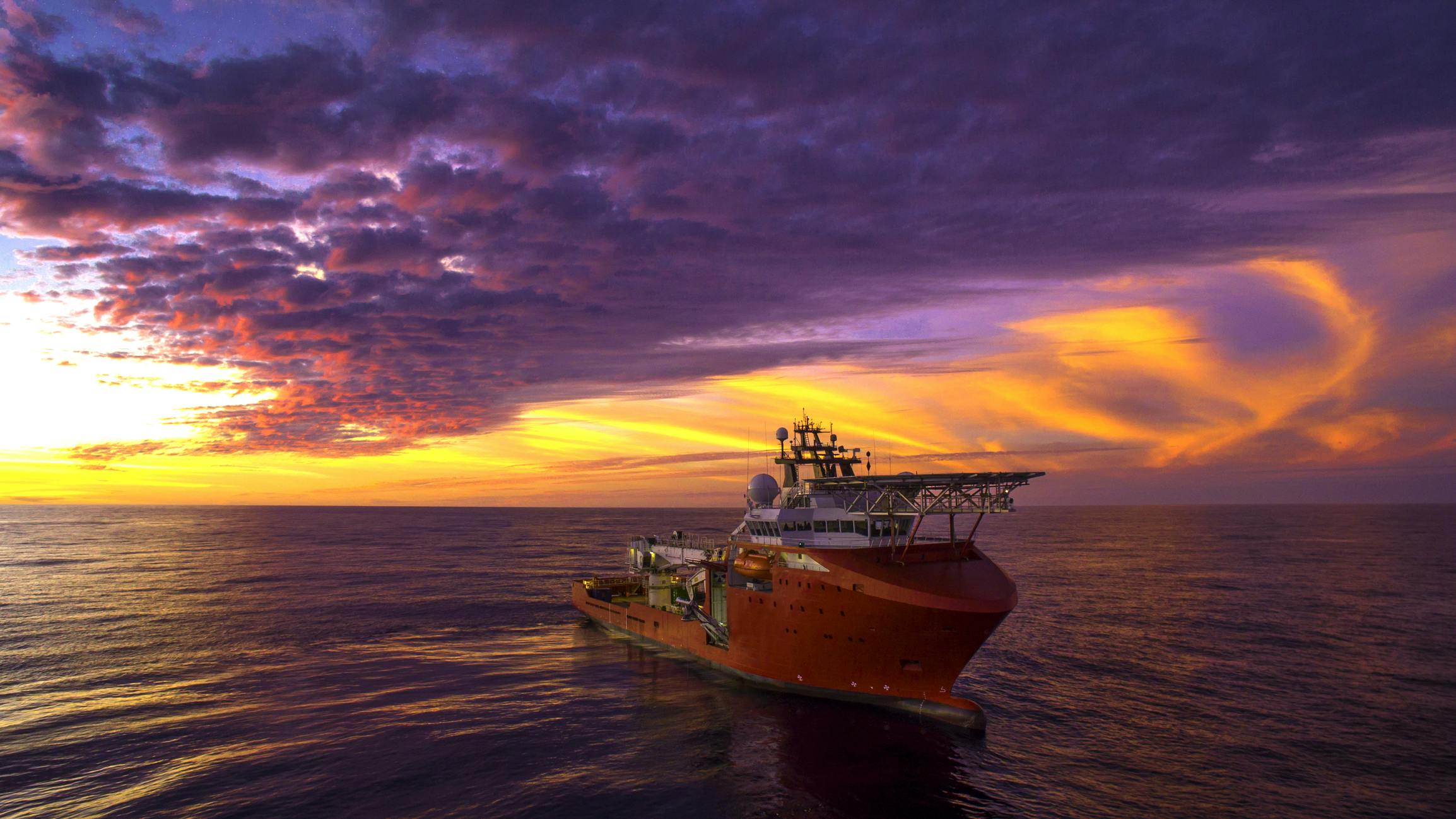 ROV vessel at sea during sunset