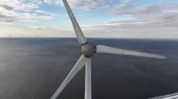 Close-up aerial perspective of a wind turbine spinning over the ocean Close-up aerial perspective of a wind turbine spinning over the ocean