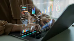Person using laptop with holographic data visualizations