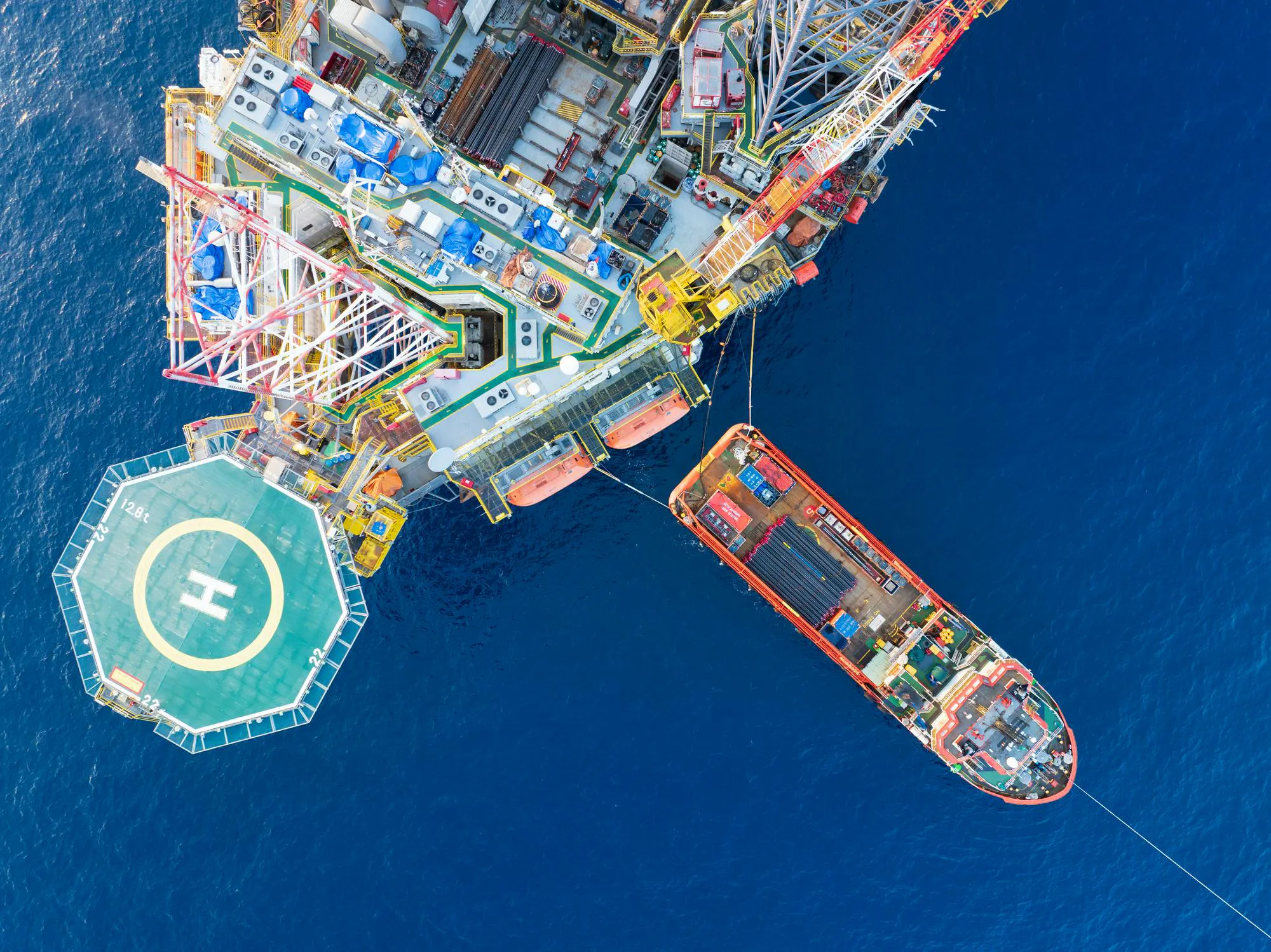 Aerial view of offshore jackup rig and a supply vessel