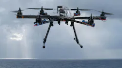 Hexacopter drone flying over the ocean