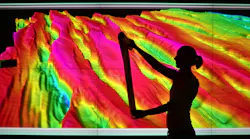 Female geoscientist examines print outs of seismic