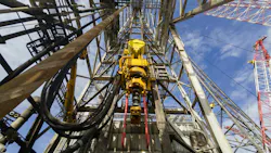Driller floor of an offshore drilling rig with top drive, pipe handler and drawworks
