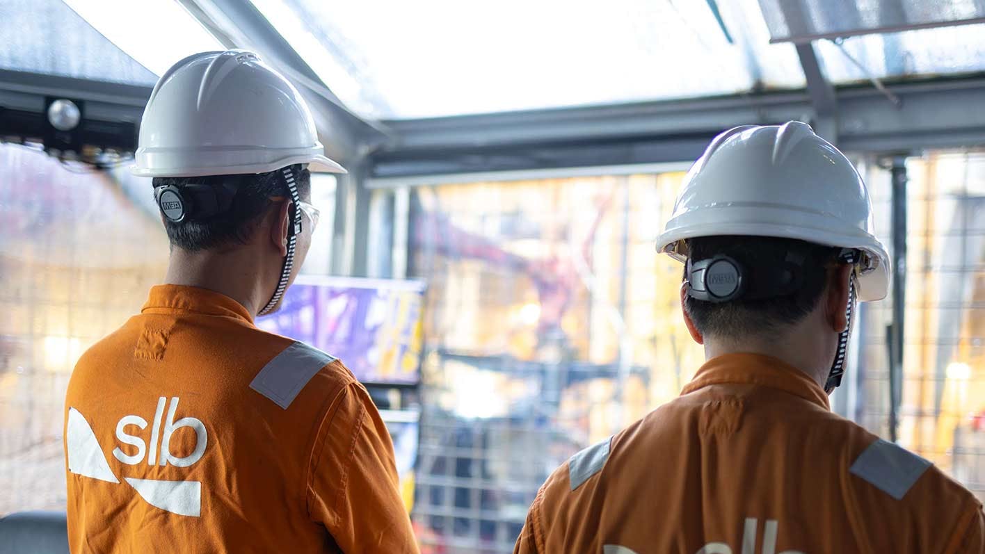 SLB personnel monitor offshore operations