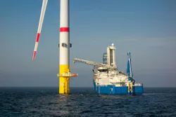 vessel actively working alongside an offshore wind turbine